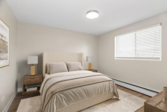 6432 N Ridge Ave Unit 3I, Chicago, IL 60626 - bedroom with a baseboard heating unit and wood finished floors