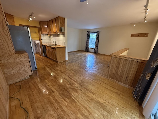 1690 Ashburn Ct Unit A, Wheaton, IL 60189 - kitchen with track lighting, freestanding refrigerator, brown cabinetry, light wood-type flooring, and tasteful backsplash