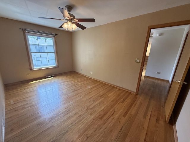 1690 Ashburn Ct Unit A, Wheaton, IL 60189 - spare room featuring light wood-style floors and a ceiling fan