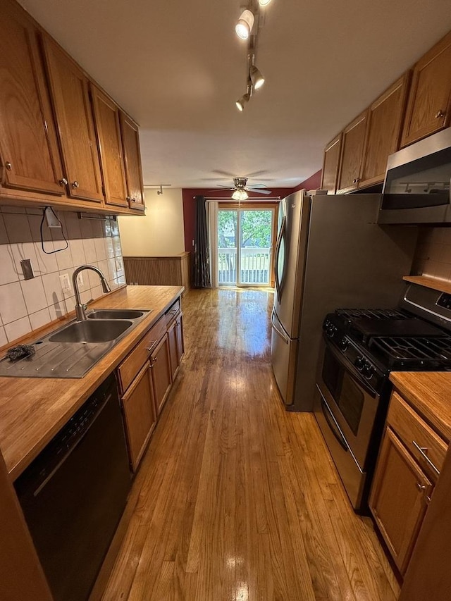 1690 Ashburn Ct Unit A, Wheaton, IL 60189 - kitchen with appliances with stainless steel finishes, butcher block countertops, brown cabinetry, and light wood finished floors