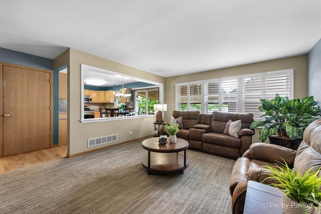 2370 Nantucket Ln, Elgin, IL 60123 - living area featuring a chandelier and baseboards