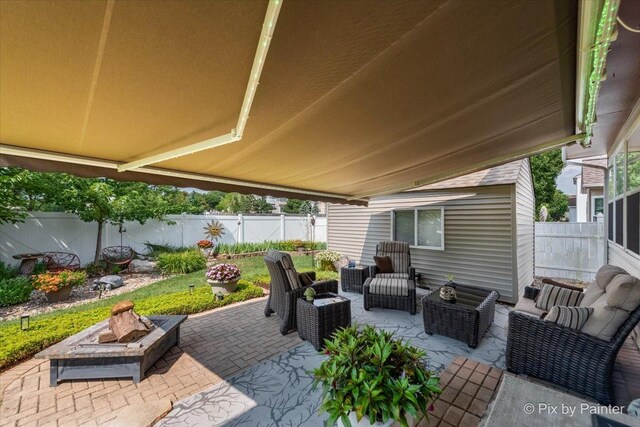 2370 Nantucket Ln, Elgin, IL 60123 - fenced backyard featuring a patio area and an outdoor living space with a fire pit