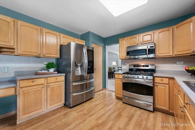 2370 Nantucket Ln, Elgin, IL 60123 - kitchen featuring stainless steel appliances, light brown cabinetry, light wood finished floors, and backsplash