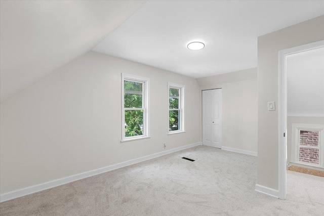 7111 S Michigan Ave, Chicago, IL 60619 - unfurnished bedroom featuring light carpet, lofted ceiling, and a closet