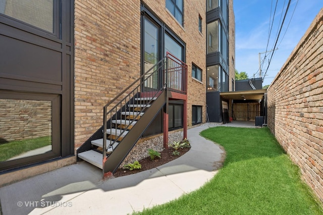 220 S Oakley Blvd, Chicago, IL 60612 - view of exterior entry with brick siding and a lawn