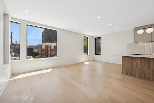 220 S Oakley Blvd, Chicago, IL 60612 - unfurnished living room featuring light wood finished floors and recessed lighting