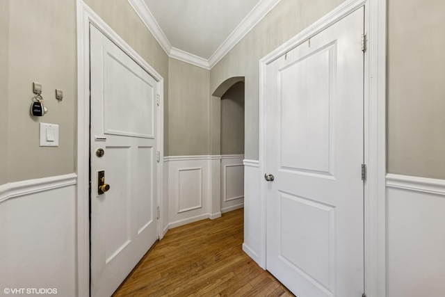 427 S Taylor Ave Unit 2N, Oak Park, IL 60304 - entryway with ornamental molding, wood finished floors, arched walkways, a decorative wall, and wainscoting