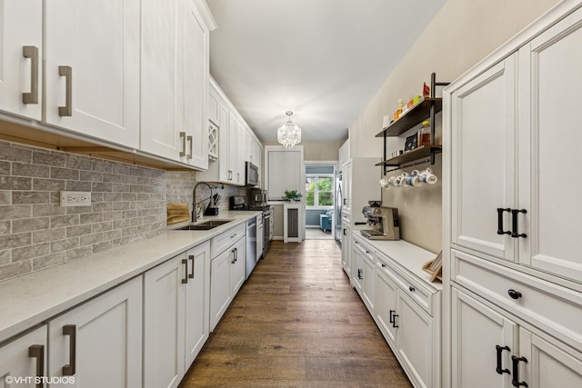 427 S Taylor Ave Unit 2N, Oak Park, IL 60304 - kitchen featuring stainless steel appliances, white cabinets, dark wood-type flooring, tasteful backsplash, and a chandelier