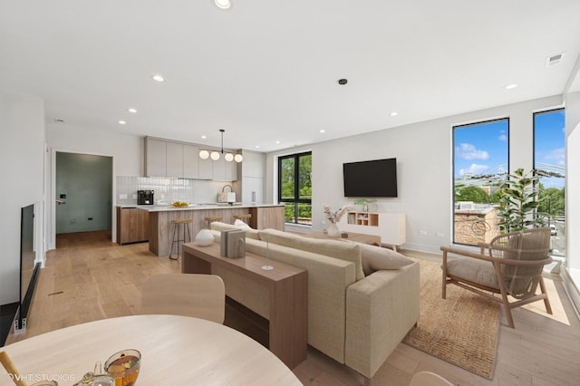 222 S Oakley Blvd Unit 3, Chicago, IL 60612 - living room featuring light wood finished floors, recessed lighting, and a chandelier
