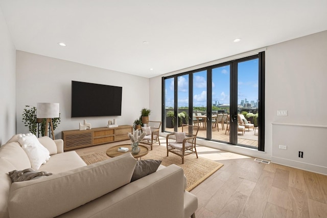 222 S Oakley Blvd Unit 3, Chicago, IL 60612 - living room featuring light wood-style flooring, expansive windows, and recessed lighting