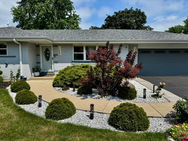 1211 Highland Dr, Prospect Heights, IL 60070 - single story home featuring a garage, driveway, a shingled roof, and brick siding