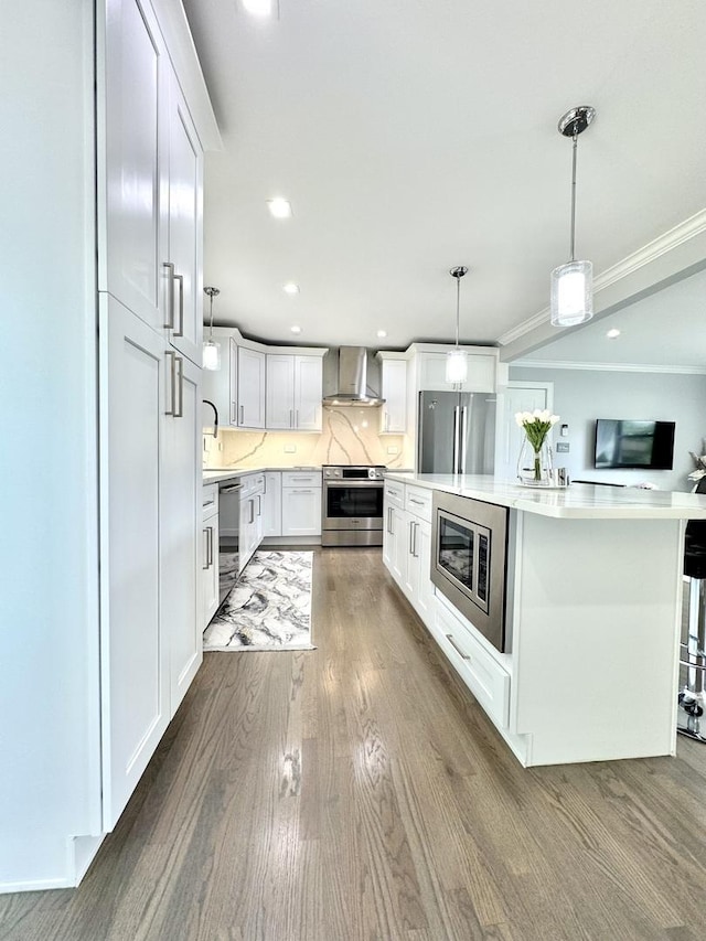 1211 Highland Dr, Prospect Heights, IL 60070 - kitchen featuring appliances with stainless steel finishes, wall chimney range hood, light countertops, wood finished floors, and white cabinetry