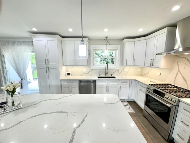 1211 Highland Dr, Prospect Heights, IL 60070 - kitchen with appliances with stainless steel finishes, wall chimney exhaust hood, white cabinets, and recessed lighting