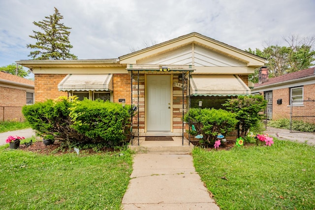 15533 Vincennes Rd, Phoenix, IL 60426 - view of front of house featuring brick siding and a front yard
