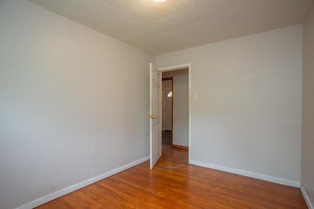 15533 Vincennes Rd, Phoenix, IL 60426 - spare room with baseboards and wood finished floors