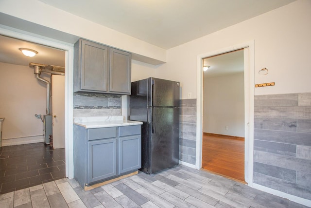 15533 Vincennes Rd, Phoenix, IL 60426 - kitchen with freestanding refrigerator, wood tiled floors, light countertops, decorative backsplash, and gray cabinets
