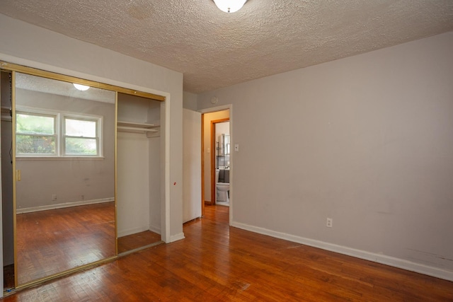 15533 Vincennes Rd, Phoenix, IL 60426 - unfurnished bedroom featuring wood finished floors, a closet, and a textured ceiling