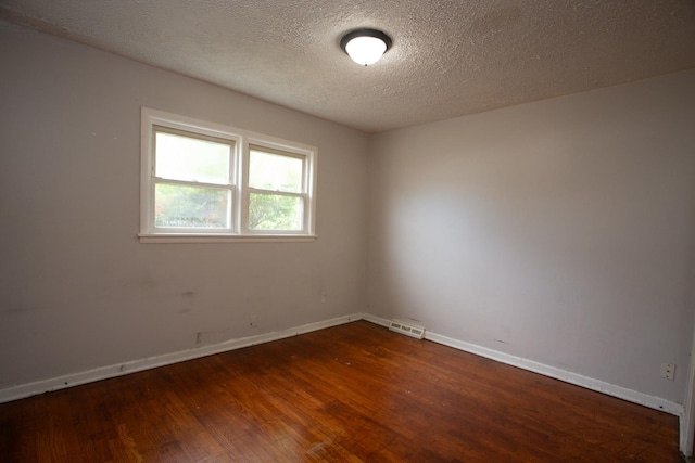 15533 Vincennes Rd, Phoenix, IL 60426 - unfurnished room with wood finished floors and a textured ceiling