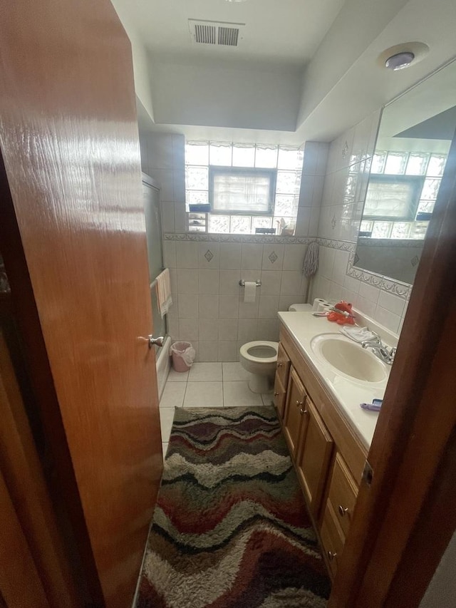 2940 N Nagle Ave, Chicago, IL 60634 - bathroom featuring a stall shower, vanity, tile patterned floors, and tile walls