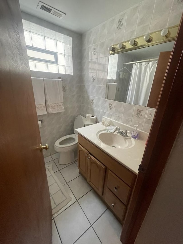 2940 N Nagle Ave, Chicago, IL 60634 - bathroom with tile patterned floors, tile walls, vanity, decorative backsplash, and a shower with shower curtain