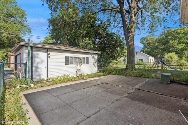 12358 S Lowe Ave, Chicago, IL 60628 - view of patio with an outdoor structure and a playground