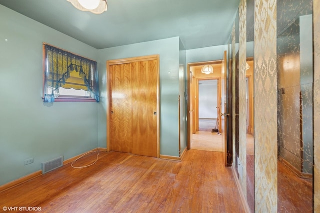 12358 S Lowe Ave, Chicago, IL 60628 - unfurnished bedroom featuring wood finished floors and a closet