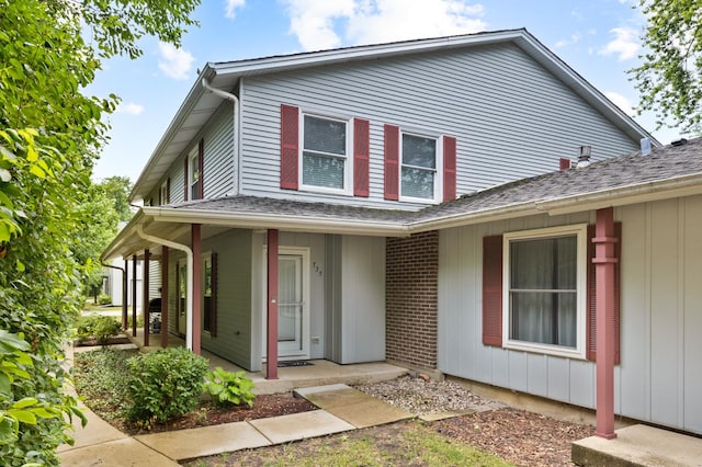 735 Wellington Ave, Elk Grove Village, IL 60007 - view of front of home with a porch, board and batten siding, and roof with shingles