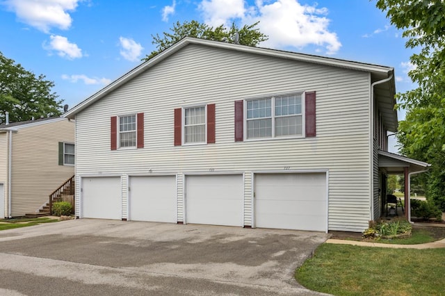 735 Wellington Ave, Elk Grove Village, IL 60007 - view of front facade with asphalt driveway and a garage