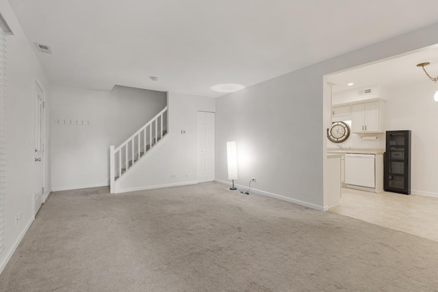 735 Wellington Ave, Elk Grove Village, IL 60007 - unfurnished living room featuring stairs, light carpet, and wine cooler