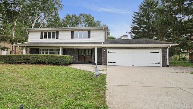 5809 Inverness Dr, Rockford, IL 61107 - traditional-style home with an attached garage, driveway, brick siding, and a front yard