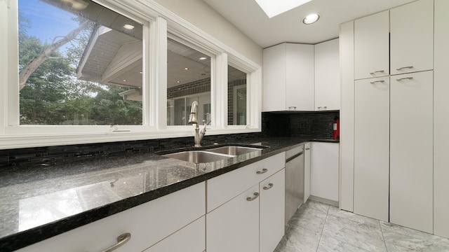 5809 Inverness Dr, Rockford, IL 61107 - kitchen with light marble finish flooring, backsplash, white cabinetry, dark stone countertops, and recessed lighting