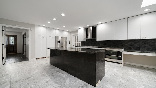 5809 Inverness Dr, Rockford, IL 61107 - kitchen featuring wall chimney exhaust hood, appliances with stainless steel finishes, modern cabinets, decorative backsplash, and recessed lighting