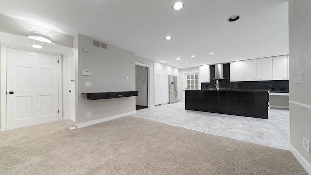 5809 Inverness Dr, Rockford, IL 61107 - kitchen featuring stainless steel fridge with ice dispenser, wall chimney exhaust hood, light colored carpet, white cabinetry, and decorative backsplash