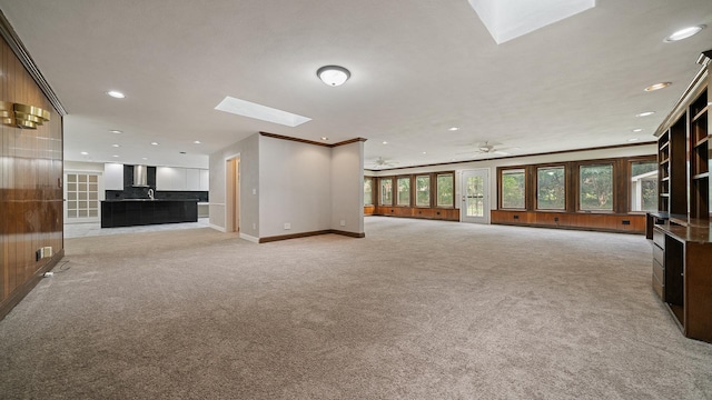 5809 Inverness Dr, Rockford, IL 61107 - unfurnished living room with a skylight, light carpet, recessed lighting, crown molding, and a ceiling fan