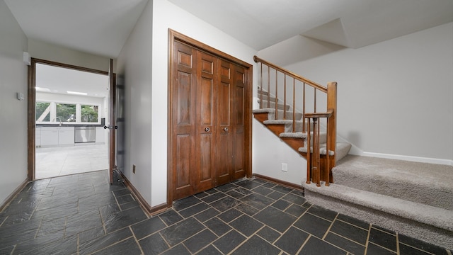 5809 Inverness Dr, Rockford, IL 61107 - foyer entrance with stairs and dark stone finish flooring
