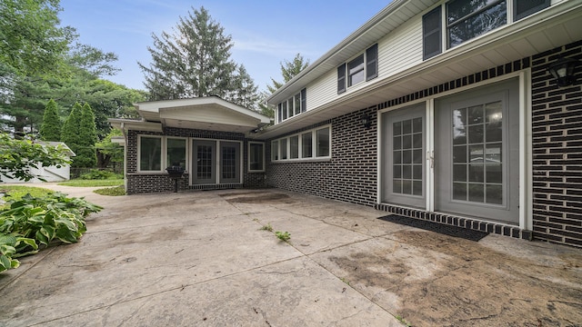 5809 Inverness Dr, Rockford, IL 61107 - back of house featuring brick siding and a patio area