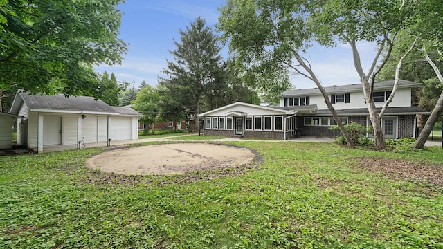 5809 Inverness Dr, Rockford, IL 61107 - view of green lawn featuring a sunroom, an outdoor structure, and a garage