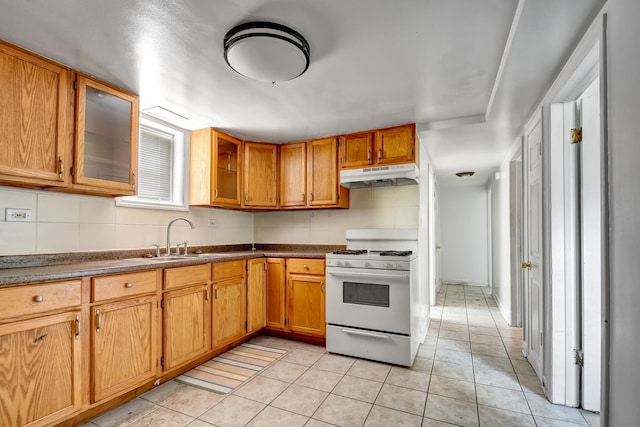 3241 S 53rd Ct, Cicero, IL 60804 - kitchen featuring under cabinet range hood, white gas range oven, light tile patterned floors, and brown cabinets