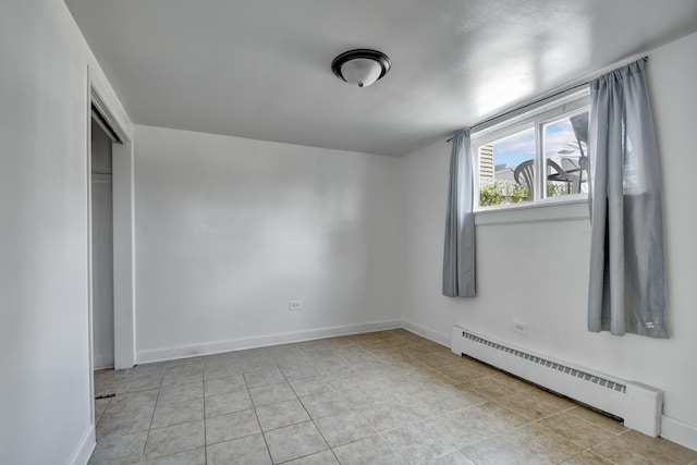 3241 S 53rd Ct, Cicero, IL 60804 - unfurnished bedroom featuring a baseboard radiator, light tile patterned flooring, and a closet