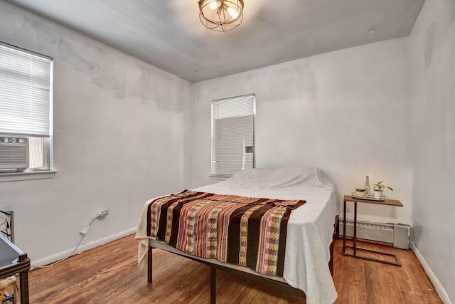 3241 S 53rd Ct, Cicero, IL 60804 - bedroom featuring a baseboard heating unit, wood finished floors, and cooling unit