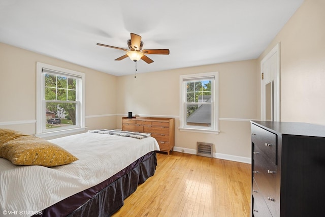 1300 Highridge Pkwy, Westchester, IL 60154 - bedroom featuring multiple windows, light wood-style flooring, and a ceiling fan