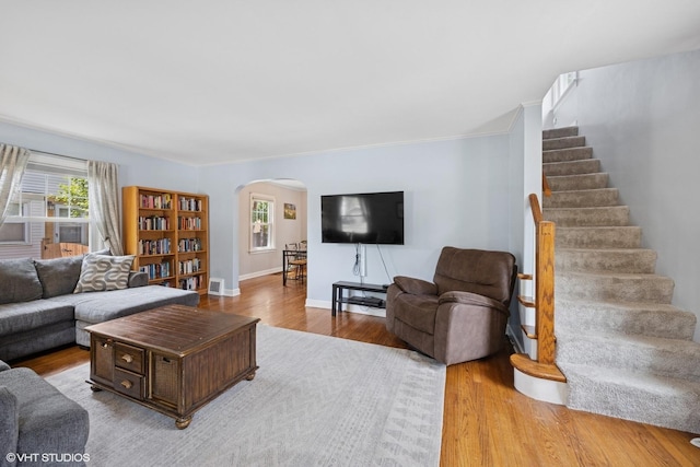 1300 Highridge Pkwy, Westchester, IL 60154 - living room featuring arched walkways, wood finished floors, stairway, and ornamental molding
