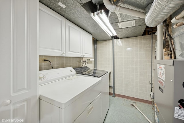 1300 Highridge Pkwy, Westchester, IL 60154 - laundry area with cabinet space, washer and dryer, and tile walls