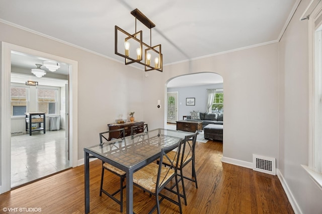 1300 Highridge Pkwy, Westchester, IL 60154 - dining area with arched walkways, plenty of natural light, wood finished floors, and crown molding