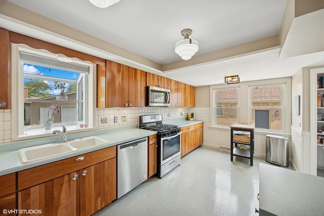1300 Highridge Pkwy, Westchester, IL 60154 - kitchen featuring stainless steel appliances, brown cabinetry, backsplash, and light countertops
