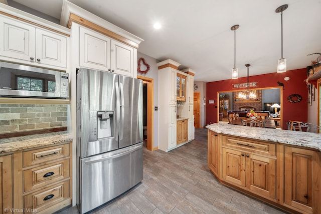 1448 Chestnut Xing, Lemont, IL 60439 - kitchen with stainless steel fridge, built in microwave, decorative backsplash, light stone counters, and light wood-style floors