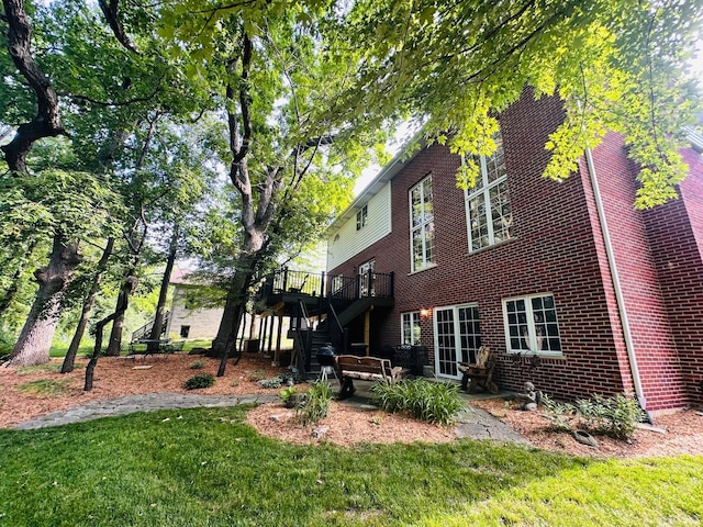 1448 Chestnut Xing, Lemont, IL 60439 - rear view of property featuring stairway, a wooden deck, brick siding, and a yard