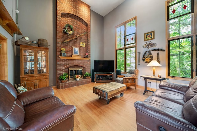 1448 Chestnut Xing, Lemont, IL 60439 - living area featuring a high ceiling, a brick fireplace, and wood finished floors
