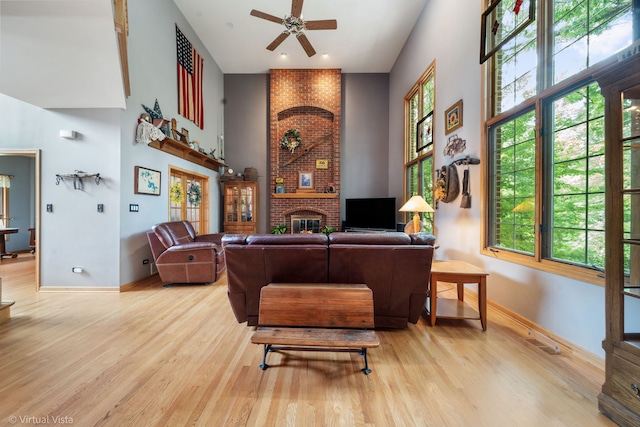 1448 Chestnut Xing, Lemont, IL 60439 - living area featuring a ceiling fan, a towering ceiling, wood finished floors, and a brick fireplace