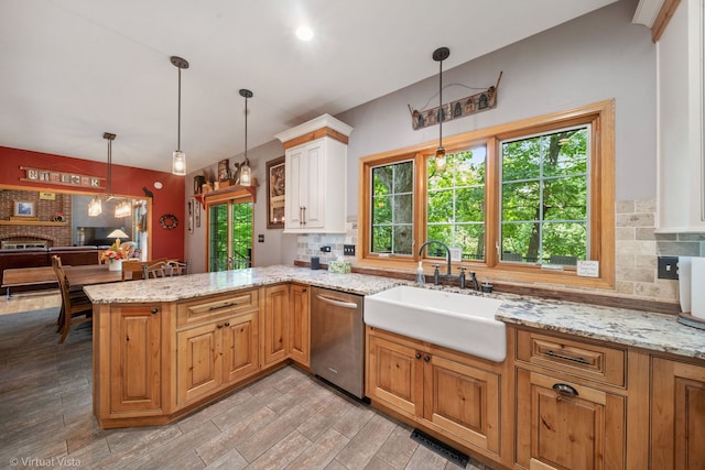 1448 Chestnut Xing, Lemont, IL 60439 - kitchen with stainless steel dishwasher, tasteful backsplash, a peninsula, light stone countertops, and pendant lighting
